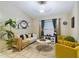 Living room features a white sofa and yellow armchairs at 6928 Sw 152Nd St, Ocala, FL 34473