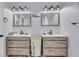 Modern bathroom with double vanity, a large mirror, and stylish light fixtures at 752 Americana Ct, Kissimmee, FL 34758