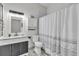 Clean bathroom with modern vanity, shower, and patterned curtain at 752 Americana Ct, Kissimmee, FL 34758