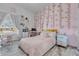 Charming bedroom with a full-size bed, desk area, and pink decor at 752 Americana Ct, Kissimmee, FL 34758