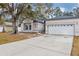 Front view of a single-story house with a white garage at 752 Americana Ct, Kissimmee, FL 34758