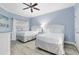 Bright bedroom with two twin beds and a ceiling fan at 7618 Sandy Ridge Dr # 103, Reunion, FL 34747