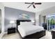 Main bedroom with king-size bed and access to a private balcony at 7618 Sandy Ridge Dr # 103, Reunion, FL 34747