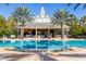 Large pool with clubhouse and palm trees at 7618 Sandy Ridge Dr # 103, Reunion, FL 34747