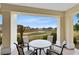 Covered patio with table and chairs, golf course view at 7618 Sandy Ridge Dr # 103, Reunion, FL 34747