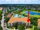 Aerial view showing condo building near pool and lake at 7654 Comrow St # 101, Kissimmee, FL 34747