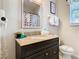 Clean bathroom with granite countertop, colorful shower curtain, and updated fixtures at 7654 Comrow St # 101, Kissimmee, FL 34747