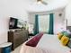 Bedroom with large bed, dresser, and window at 7654 Comrow St # 101, Kissimmee, FL 34747