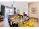 Open concept dining area with glass top table and yellow chairs at 7654 Comrow St # 101, Kissimmee, FL 34747