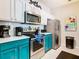 Modern teal kitchen with stainless steel appliances at 7654 Comrow St # 101, Kissimmee, FL 34747