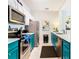 Modern teal kitchen with stainless steel appliances at 7654 Comrow St # 101, Kissimmee, FL 34747