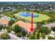 Aerial view of condo community, showcasing building and lake at 7664 Comrow St # 301, Kissimmee, FL 34747