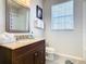 Bathroom with shower, toilet, and dark brown vanity at 7664 Comrow St # 301, Kissimmee, FL 34747