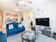 Spacious living room with blue sofas and a glass coffee table at 7664 Comrow St # 301, Kissimmee, FL 34747