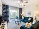 Comfortable living room with blue sofa and access to balcony at 7664 Comrow St # 301, Kissimmee, FL 34747