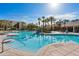 Large community pool with surrounding lounge chairs at 7664 Comrow St # 301, Kissimmee, FL 34747