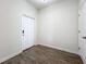 Simple entryway with wood-look floors and white door at 11024 Folklore Street, Winter Garden, FL 34787