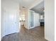 Entryway with wood-look floors, white door, and view into an office at 11024 Folklore Street, Winter Garden, FL 34787