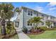 Two-story light blue home with palm trees and landscaping at 12439 Shipwatch St, Orlando, FL 32832