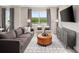 Living room with gray sofa and large windows with a view at 12439 Shipwatch St, Orlando, FL 32832