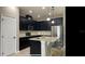 Modern kitchen with dark cabinetry and granite countertops at 1406 Swinton Ct, Sanford, FL 32771