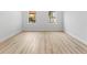 Minimalist bedroom with wood-look flooring, two windows, and neutral wall paint at 15033 Sw 35Th Cir, Ocala, FL 34473