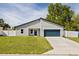 Charming single-story home features a well-manicured lawn, a two-car garage, and a classic white fence at 15033 Sw 35Th Cir, Ocala, FL 34473
