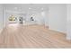 Bright, open-concept living room and kitchen area with stainless steel appliances and light wood flooring at 15033 Sw 35Th Cir, Ocala, FL 34473