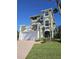 Three-story house with a two-car garage and landscaped yard at 156 Coquina Key Dr, Ormond Beach, FL 32176