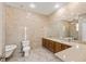 Bright bathroom with dual sinks, a soaking tub, and tiled walls and floors at 1569 Victoria Way, Winter Garden, FL 34787
