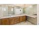 Elegant bathroom featuring dual sinks, a spacious countertop, and wood cabinets at 1569 Victoria Way, Winter Garden, FL 34787