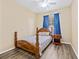 Cozy bedroom with wood-style floors, a ceiling fan, a window, and a charming wood bed frame at 1569 Victoria Way, Winter Garden, FL 34787