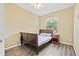 Bedroom featuring wood laminate flooring, a window, and neutral paint at 1569 Victoria Way, Winter Garden, FL 34787
