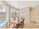 Charming dining nook bathed in natural light, featuring a modern chandelier and views of the pool at 1569 Victoria Way, Winter Garden, FL 34787