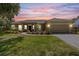 Attractive single-story home with a landscaped yard and paved driveway at 1569 Victoria Way, Winter Garden, FL 34787