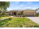 Charming single-story home featuring a well-manicured lawn and an attached two-car garage at 1569 Victoria Way, Winter Garden, FL 34787