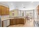 Bright kitchen with stainless steel appliances, tiled floors, and a dining area near large windows at 1569 Victoria Way, Winter Garden, FL 34787
