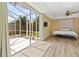 Bedroom with a screened-in patio access, ceiling fan, and wood laminate flooring at 1569 Victoria Way, Winter Garden, FL 34787