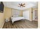 Main bedroom featuring a ceiling fan, wood laminate flooring, and an ensuite bathroom at 1569 Victoria Way, Winter Garden, FL 34787