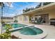 Inviting pool area with a spa, a covered patio, outdoor seating, and a barbecue grill at 1569 Victoria Way, Winter Garden, FL 34787