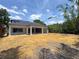 Exterior view of the rear of the home with large covered patio and expansive yard, ready for landscaping at 1830 Park Lake St, Orlando, FL 32803