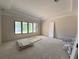 Bright bedroom with a tray ceiling and a wall of windows offering plenty of natural light at 1830 Park Lake St, Orlando, FL 32803