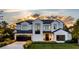 Stunning two-story home with a modern design, landscaped lawn, and a three-car garage at 1830 Park Lake St, Orlando, FL 32803