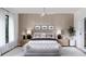 Bright main bedroom with wood-paneled walls, a plush bed, and plenty of natural light at 1830 Park Lake St, Orlando, FL 32803
