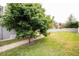 Large backyard with a grassy area and a walkway next to a wall at 2225 Kettle Dr, Orlando, FL 32835