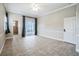 Spacious room with tiled floor, ceiling fan, and access to a screened patio at 2225 Kettle Dr, Orlando, FL 32835