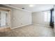 Bedroom with neutral walls, tile floors and access to bathroom with large window at 2225 Kettle Dr, Orlando, FL 32835