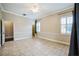 An open and bright bedroom with tiled floors, a ceiling fan, and access to an ensuite at 2225 Kettle Dr, Orlando, FL 32835
