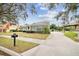 Charming single Gathering home featuring a manicured lawn and a long driveway leading to the garage at 2225 Kettle Dr, Orlando, FL 32835