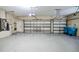 Spacious three-car garage featuring an epoxy floor and ample storage space at 2225 Kettle Dr, Orlando, FL 32835